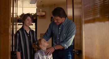 Movie still from “We Bought a Zoo” (2011), directed by Cameron Crowe – A man and two young boys standing in a room; Medium shot, Over the shoulder angle