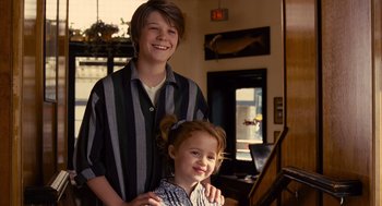 Movie still from “We Bought a Zoo” (2011), directed by Cameron Crowe – A boy and a little girl posing for a picture; Medium shot, Over the shoulder angle