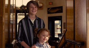 Movie still from “We Bought a Zoo” (2011), directed by Cameron Crowe – A boy and a little girl posing for a picture; Medium shot, Over the shoulder angle