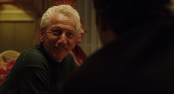 Movie still from “We Own the Night” (2007), directed by James Gray – An older man smiling at the camera while a younger man looks at him; Close Up shot, Over the shoulder angle