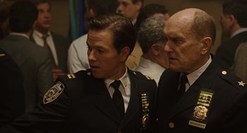 Movie still from “We Own the Night” (2007), directed by James Gray – Two men in military uniforms standing next to each other; Close Up shot, Over the shoulder angle