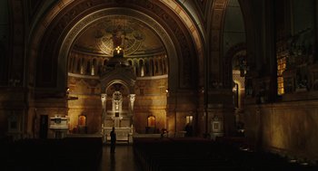 Movie still from “We Own the Night” (2007), directed by James Gray – A large cathedral with a cross on the top of the wall; Extreme Wide shot, Low angle