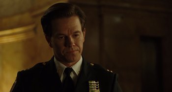 Movie still from “We Own the Night” (2007), directed by James Gray – A person wearing a suit and tie; Close Up shot, Over the shoulder angle