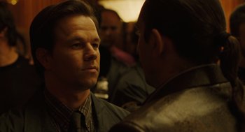 Movie still from “We Own the Night” (2007), directed by James Gray – A man in a suit and tie talking to another man in a leather jacket; Close Up shot, Over the shoulder angle