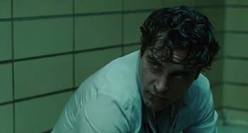 Movie still from “We Own the Night” (2007), directed by James Gray – A person wearing a white shirt; Close Up shot, Low angle