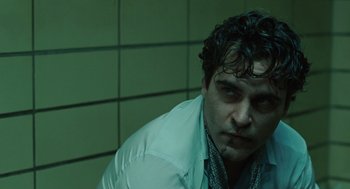 Movie still from “We Own the Night” (2007), directed by James Gray – A person wearing a white jacket; Close Up shot, Low angle