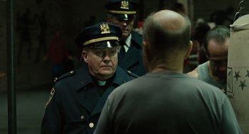 Movie still from “We Own the Night” (2007), directed by James Gray – A group of men in police uniforms standing next to each other; Close Up shot, Over the shoulder angle