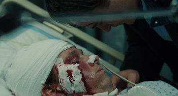 Movie still from “We Own the Night” (2007), directed by James Gray – A man with a bandaged head is in a hospital bed; Close Up shot, Over the shoulder angle