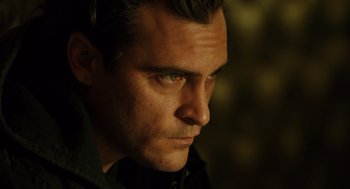Movie still from “We Own the Night” (2007), directed by James Gray – A man's face with green eyes; Close Up shot, Low angle