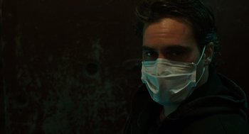 Movie still from “We Own the Night” (2007), directed by James Gray – A man wearing a face mask in the dark; Close Up shot, Low angle