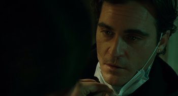 Movie still from “We Own the Night” (2007), directed by James Gray – A person wearing a suit and tie; Close Up shot, Over the shoulder angle
