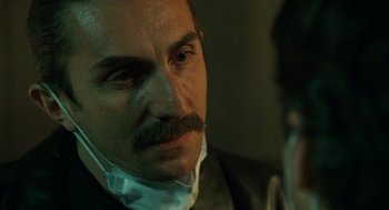 Movie still from “We Own the Night” (2007), directed by James Gray – A person wearing a face mask; Close Up shot, Over the shoulder angle