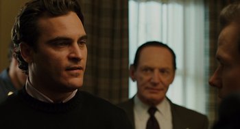 Movie still from “We Own the Night” (2007), directed by James Gray – A man and a man standing next to each other in front of a window; Close Up shot, Over the shoulder angle