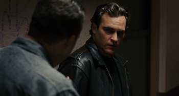Movie still from “We Own the Night” (2007), directed by James Gray – A man wearing a leather jacket looking at himself in the mirror; Close Up shot, Over the shoulder angle