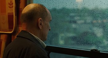 Movie still from “We Own the Night” (2007), directed by James Gray – A man sitting in front of a window looking outside; Close Up shot, Over the shoulder angle