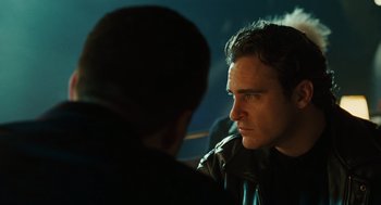 Movie still from “We Own the Night” (2007), directed by James Gray – A man is talking to another man in a dark room; Close Up shot, Over the shoulder angle