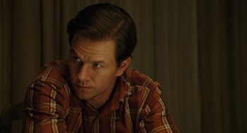 Movie still from “We Own the Night” (2007), directed by James Gray – A person wearing a plaid shirt; Close Up shot, Over the shoulder angle