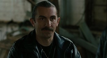 Movie still from “We Own the Night” (2007), directed by James Gray – A person wearing a leather jacket; Close Up shot, Over the shoulder angle
