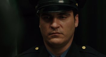 Movie still from “We Own the Night” (2007), directed by James Gray – A person wearing a uniform; Close Up shot, Over the shoulder angle