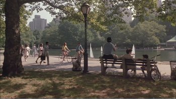 Movie still from “Weekend at Bernie's” (1989), directed by Ted Kotcheff – A group of people riding bikes in a park; Extreme Wide shot, High angle