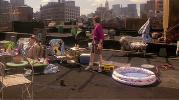 Movie still from “Weekend at Bernie's” (1989), directed by Ted Kotcheff – A woman standing on the roof of a building next to a bunch of toys; Wide shot, High angle