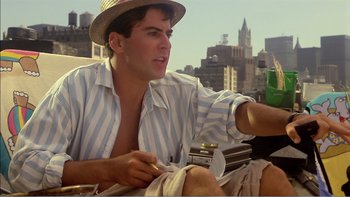 Movie still from “Weekend at Bernie's” (1989), directed by Ted Kotcheff – A man in a straw hat sitting on a bench; Medium shot, Low angle