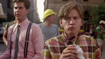 Movie still from “Weekend at Bernie's” (1989), directed by Ted Kotcheff – A young man holding a cup in his hand; Medium shot, Over the shoulder angle