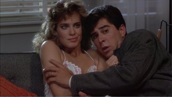 Movie still from “Weekend at Bernie's” (1989), directed by Ted Kotcheff – A man and a woman posing for a picture; Close Up shot, Over the shoulder angle