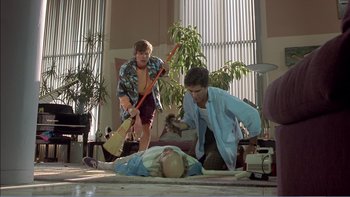 Movie still from “Weekend at Bernie's” (1989), directed by Ted Kotcheff – A group of people that are standing up in a living room; Wide shot, Low angle