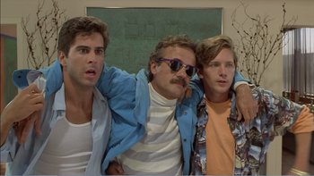 Movie still from “Weekend at Bernie's” (1989), directed by Ted Kotcheff – A group of young men standing next to each other in a room; Medium shot, Low angle