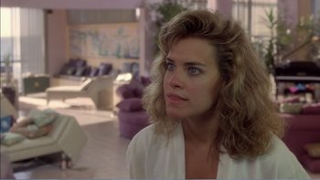 Movie still from “Weekend at Bernie's” (1989), directed by Ted Kotcheff – A person wearing a white shirt; Close Up shot, Over the shoulder angle