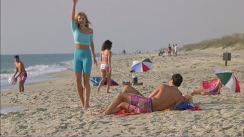 Movie still from “Weekend at Bernie's” (1989), directed by Ted Kotcheff – A man and a woman on the beach; Wide shot, High angle