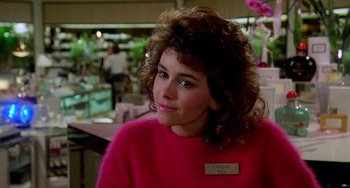 A person wearing a pink sweater