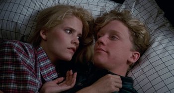 A man and a woman laying in bed together