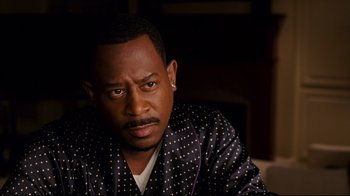 Movie still from “Welcome Home, Roscoe Jenkins” (2008), directed by Malcolm D. Lee – A person wearing a robe; Close Up shot, Over the shoulder angle