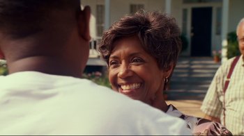 Movie still from “Welcome Home, Roscoe Jenkins” (2008), directed by Malcolm D. Lee – An older woman smiling at a younger man in front of a house; Close Up shot, Over the shoulder angle