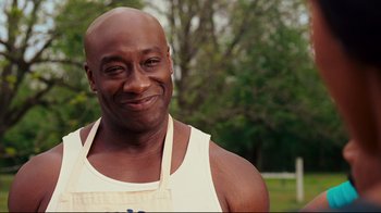 Movie still from “Welcome Home, Roscoe Jenkins” (2008), directed by Malcolm D. Lee – A person wearing an apron; Close Up shot, Over the shoulder angle