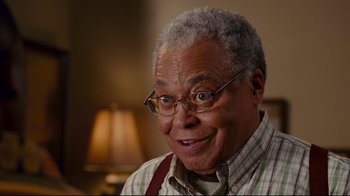 Movie still from “Welcome Home, Roscoe Jenkins” (2008), directed by Malcolm D. Lee – An older man wearing glasses and an apron; Close Up shot, Over the shoulder angle