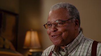 Movie still from “Welcome Home, Roscoe Jenkins” (2008), directed by Malcolm D. Lee – An older man wearing glasses is smiling for the camera; Close Up shot, Low angle