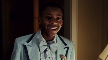 Movie still from “Welcome Home, Roscoe Jenkins” (2008), directed by Malcolm D. Lee – A young man wearing a blue suit and bow tie; Close Up shot, Low angle
