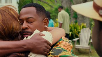 Movie still from “Welcome Home, Roscoe Jenkins” (2008), directed by Malcolm D. Lee – A man is hugging another man outside in a yard; Close Up shot, Over the shoulder angle