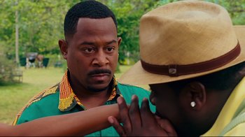 Movie still from “Welcome Home, Roscoe Jenkins” (2008), directed by Malcolm D. Lee – A man in green shirt and brown hat talking to another man in green shirt; Close Up shot, Over the shoulder angle