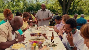 Movie still from “Welcome Home, Roscoe Jenkins” (2008), directed by Malcolm D. Lee – A group of people sitting at a table with food; Medium shot, High angle