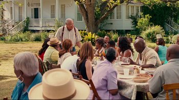 Movie still from “Welcome Home, Roscoe Jenkins” (2008), directed by Malcolm D. Lee – An older man standing in front of a group of diners; Wide shot, Over the shoulder angle