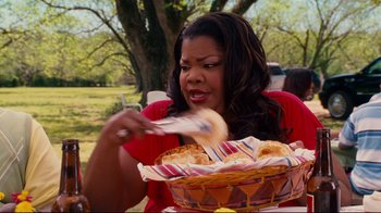 Movie still from “Welcome Home, Roscoe Jenkins” (2008), directed by Malcolm D. Lee – A woman eating a basket full of food; Medium shot, Over the shoulder angle
