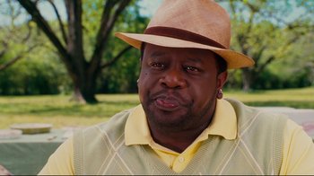 Movie still from “Welcome Home, Roscoe Jenkins” (2008), directed by Malcolm D. Lee – A person wearing a hat with trees in the background; Close Up shot, Over the shoulder angle