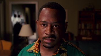 Movie still from “Welcome Home, Roscoe Jenkins” (2008), directed by Malcolm D. Lee – A person wearing a green shirt; Close Up shot, High angle
