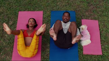 Movie still from “Welcome Home, Roscoe Jenkins” (2008), directed by Malcolm D. Lee – A man and a woman and a dog are doing yoga; Wide shot, Low angle