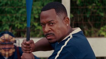 Movie still from “Welcome Home, Roscoe Jenkins” (2008), directed by Malcolm D. Lee – A person holding a baseball bat; Close Up shot, Over the shoulder angle