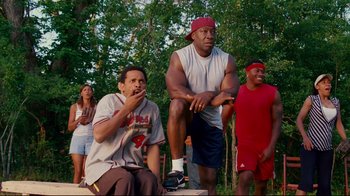 Movie still from “Welcome Home, Roscoe Jenkins” (2008), directed by Malcolm D. Lee – A group of men standing next to each other in the grass; Medium shot, Low angle